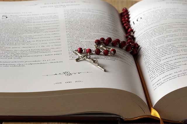 A rosary resting on an open book